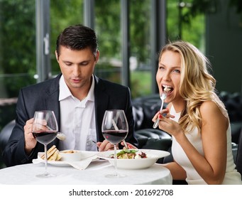 Couple Eating In Restaurant With A Red Wine 