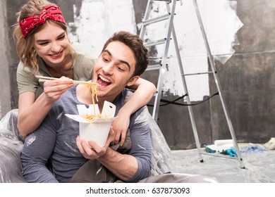 Couple Eating Thai Food While Resting During Renovation Home Process