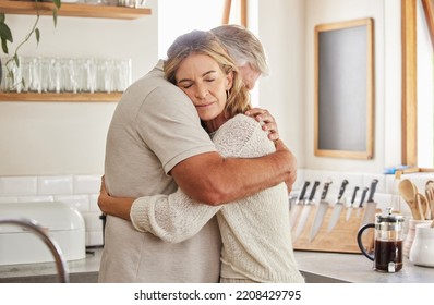 Couple, elderly and hug in kitchen in home together, romance and love. Care, man and woman in retirement love, marriage and embrace in sad moment for support, comfort and unity as married people - Powered by Shutterstock