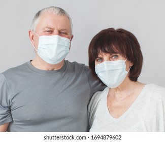 Couple Of Elderly People In Medical Masks. Mature Man And Woman In The Period Of The Pandemic And Quarantine Coronavirus Studio Shot