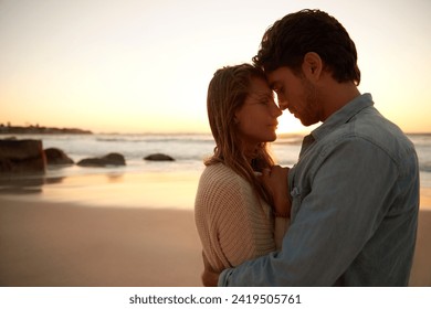 Couple, embrace and relax on beach at sunset for bonding marriage or vacation, weekend or peace. Man, woman and hugging at sea for calm on tropical holiday for coast adventure, summer or partnership - Powered by Shutterstock