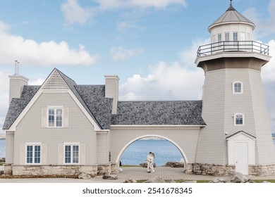 Couple embrace under the arch of a lighthouse on the lake. A cape cod coastal yet traditional aesthetic. - Powered by Shutterstock