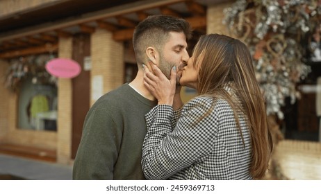 A couple embraces in a kiss on a city street, capturing an intimate moment amidst an urban backdrop. - Powered by Shutterstock