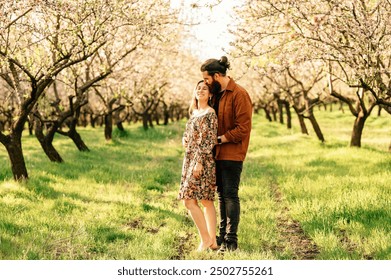 A Couple Embracing Each Other in a Beautiful Blooming Orchard, Surrounded by Nature - Powered by Shutterstock