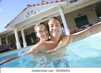 Couple Embracing In Private Swimming Pool