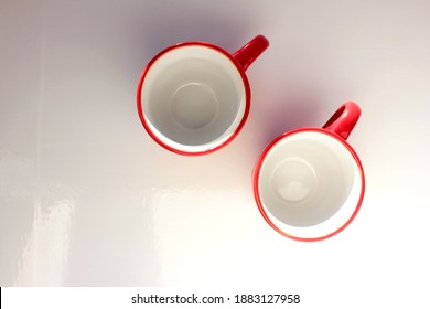 Couple Of Empty Red Espresso Coffee Cups On White Table. Overhead View. Copy Space