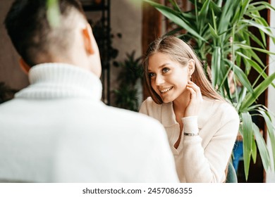 Couple Engaged in Conversation at a Cozy Cafe During Daytime