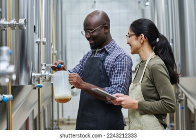 Couple of engineers tasting fresh beer - Powered by Shutterstock