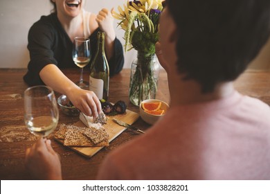 couple enjoying appetizers and wine on rustic wood table - Powered by Shutterstock