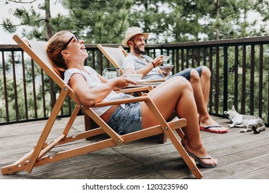 Couple enjoying coffee on a balcony in the mountains - Powered by Shutterstock