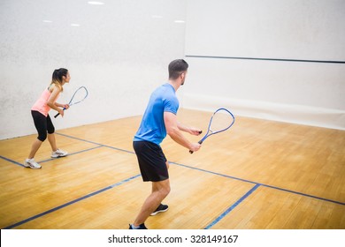 Couple enjoying a game of squash in the squash court