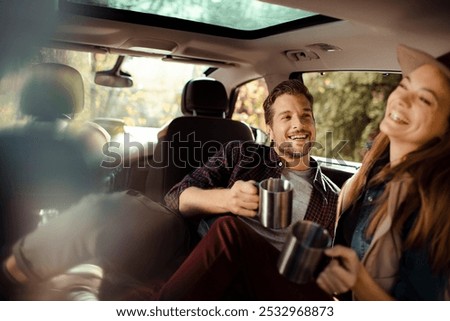 Similar – Two young women resting sitting inside of car