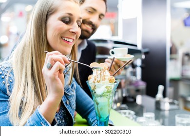 Couple Enjoying An Ice Cream Sundae In Cafe