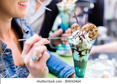 Couple Enjoying An Ice Cream Sundae In Cafe