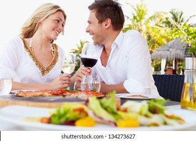 Couple Enjoying Meal In Outdoor Restaurant - Powered by Shutterstock