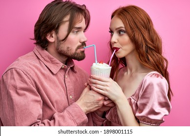 Couple Enjoying Milk Cocktail Drinking From One Glass With Two Straws, Man And Woman On Date. 14 February, St Valentines Day Concept, Love