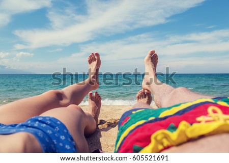 Couple enjoying on the sandy ocean / sea beach.