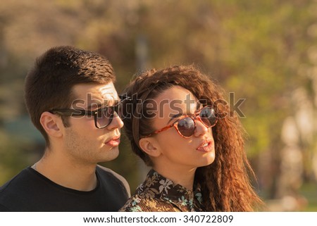 Similar – Smiling young woman looking at camera over sunglasses