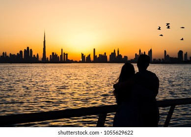 Couple enjoying panoramic view of Dubai at sunset