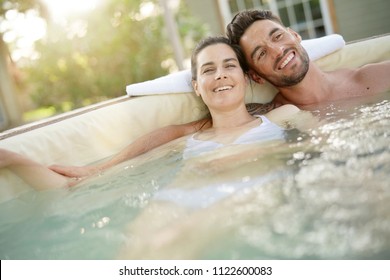 Couple Enjoying Relaxing Time In Hot Tub Water