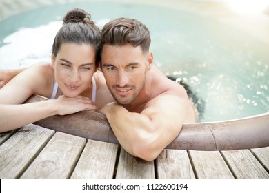 Couple Enjoying Relaxing Time In Hot Tub Water