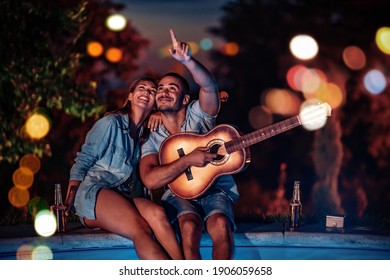 Couple Enjoying Summertime Next To Swimming Pool,enjoying In Music.