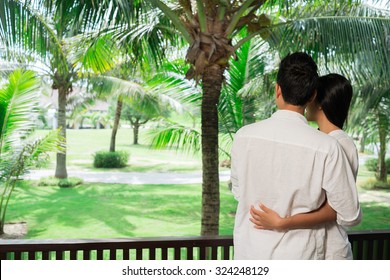 Couple enjoying the view from hotel balcony, view from the back - Powered by Shutterstock