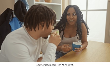 A couple enjoys a conversation over coffee in a cozy, well-lit living room, exuding warmth and love. - Powered by Shutterstock