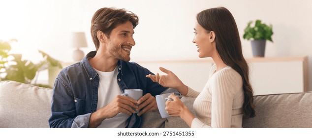Couple Enjoys Conversation While Drinking Coffee in a Cozy Living Room Setting