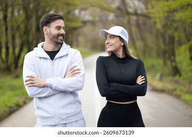 A couple exchanges smiles while jogging together on a scenic path, celebrating their shared passion for fitness and fun.