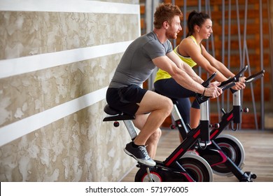 Couple Exercises Legs On Bike In Gym