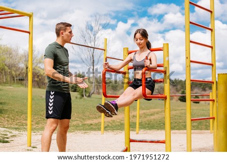 Couple exercising at outdoor gym