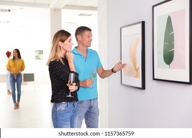 Couple At Exhibition In Art Gallery