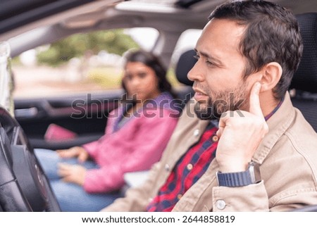 Couple experiencing car problems realizing they have a mechanical failure while traveling by car