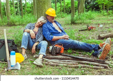 couple of expert woodsmen taking a break drinking coffee and sleeping - Powered by Shutterstock