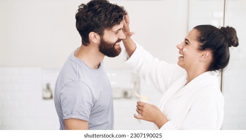 Couple, face skincare cream and bathroom with smile, helping hand and morning together in home. Woman, man and skin wellness for help, care or laughing with product for lifestyle, beauty or health - Powered by Shutterstock