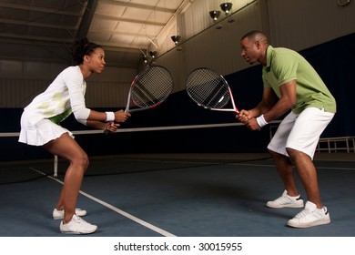 A Couple Faces Off At Tennis