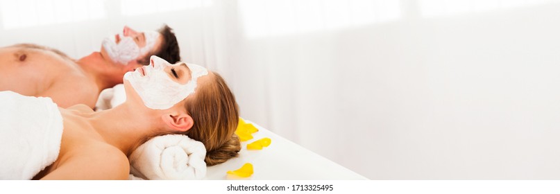 Couple At Facial Spa Getting Skin Face Mask Treatment 