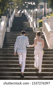 Couple Family Going Up By Stairs Outdoors In Wedding Sunny Day