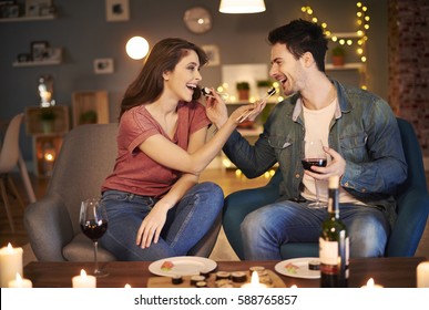 Couple feeding each other over dinner 