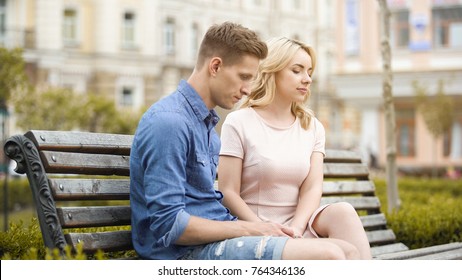 Couple Feeling Awkward, Sitting On Bench In Silence, Crisis In Relationship