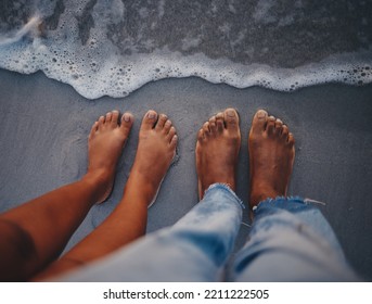 Couple feet, beach sand and water at ocean waves, nature and summer travel for vacation, honeymoon date and tropical holiday outdoors. Closeup above man, woman and foot toes at sea, relax and freedom