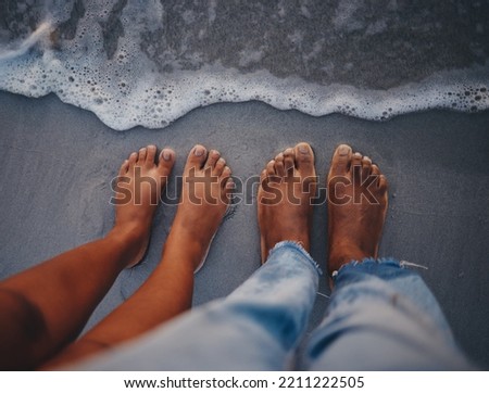 Couple feet, beach sand and water at ocean waves, nature and summer travel for vacation, honeymoon date and tropical holiday outdoors. Closeup above man, woman and foot toes at sea, relax and freedom