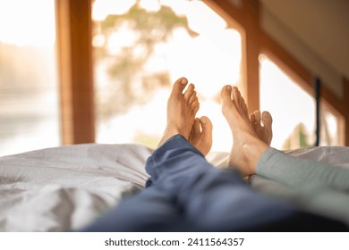 Couple feet relax in the bed at home.
 - Powered by Shutterstock