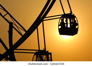 A Couple In Ferris Wheel, Shot When Sunset