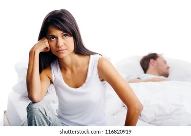 Couple Fighting In Bed, Woman Upset, Thinking And Man Sleeping In Background. Unhappy Relationship