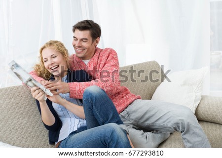 Couple fighting for newspaper