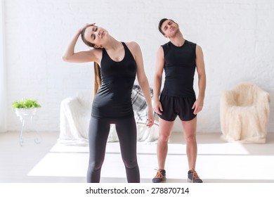 Couple Fit Woman And Man Working Warm Up Neck At Gym Fitness, Sport, Training And Lifestyle Concept.