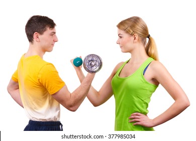 Couple fit woman and strong man exercising with dumbbells. Muscular guy and fitness blonde girl lifting weights. Bodybuilding.