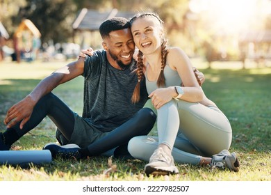 Couple, fitness and sitting on grass, park or lawn together in sunshine for fitness, wellness and health. Interracial relationship diversity or black man with woman, relax or rest at outdoor training - Powered by Shutterstock